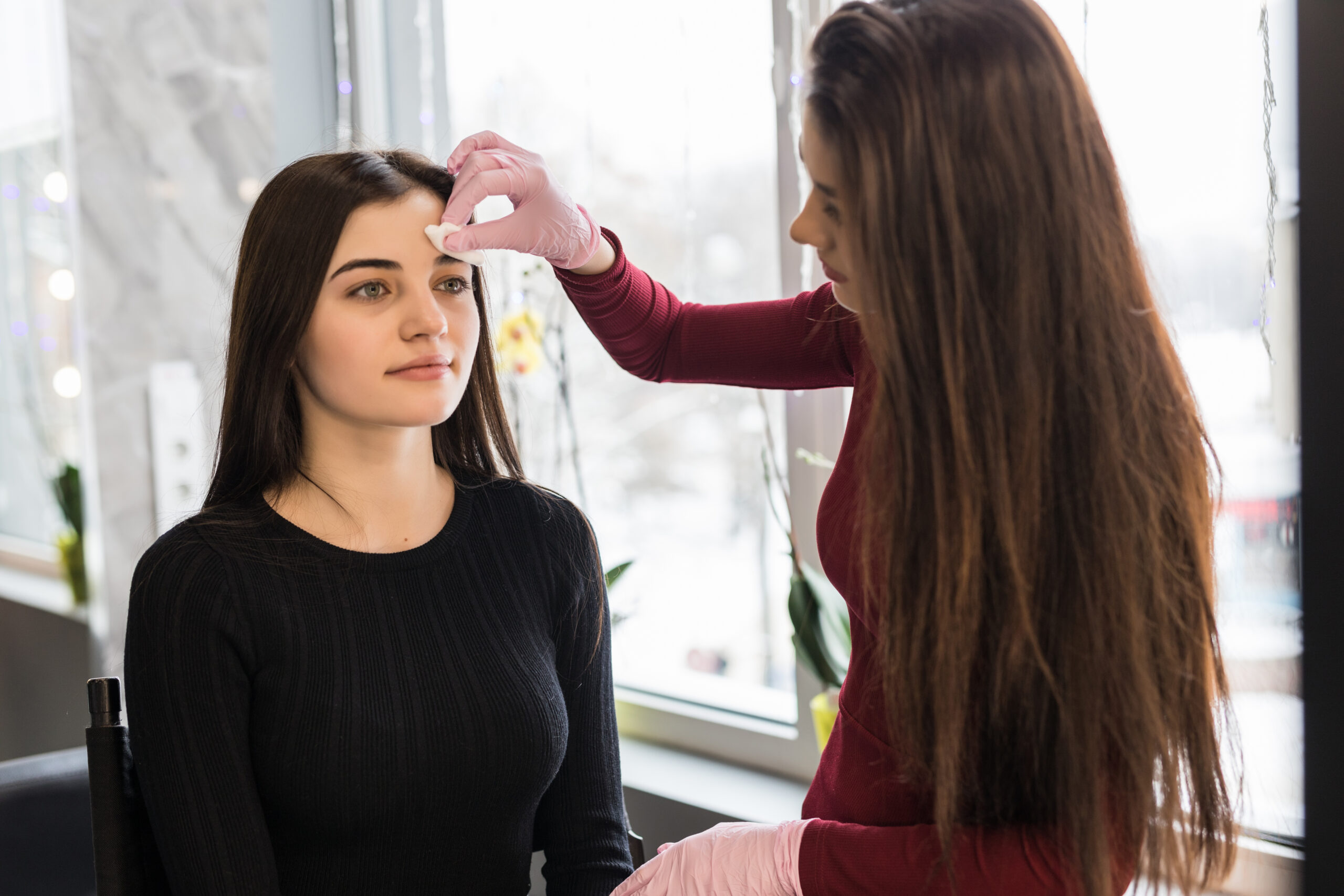 Best eyebrow threading salon Brooklyn: technician performing precise brow treatment