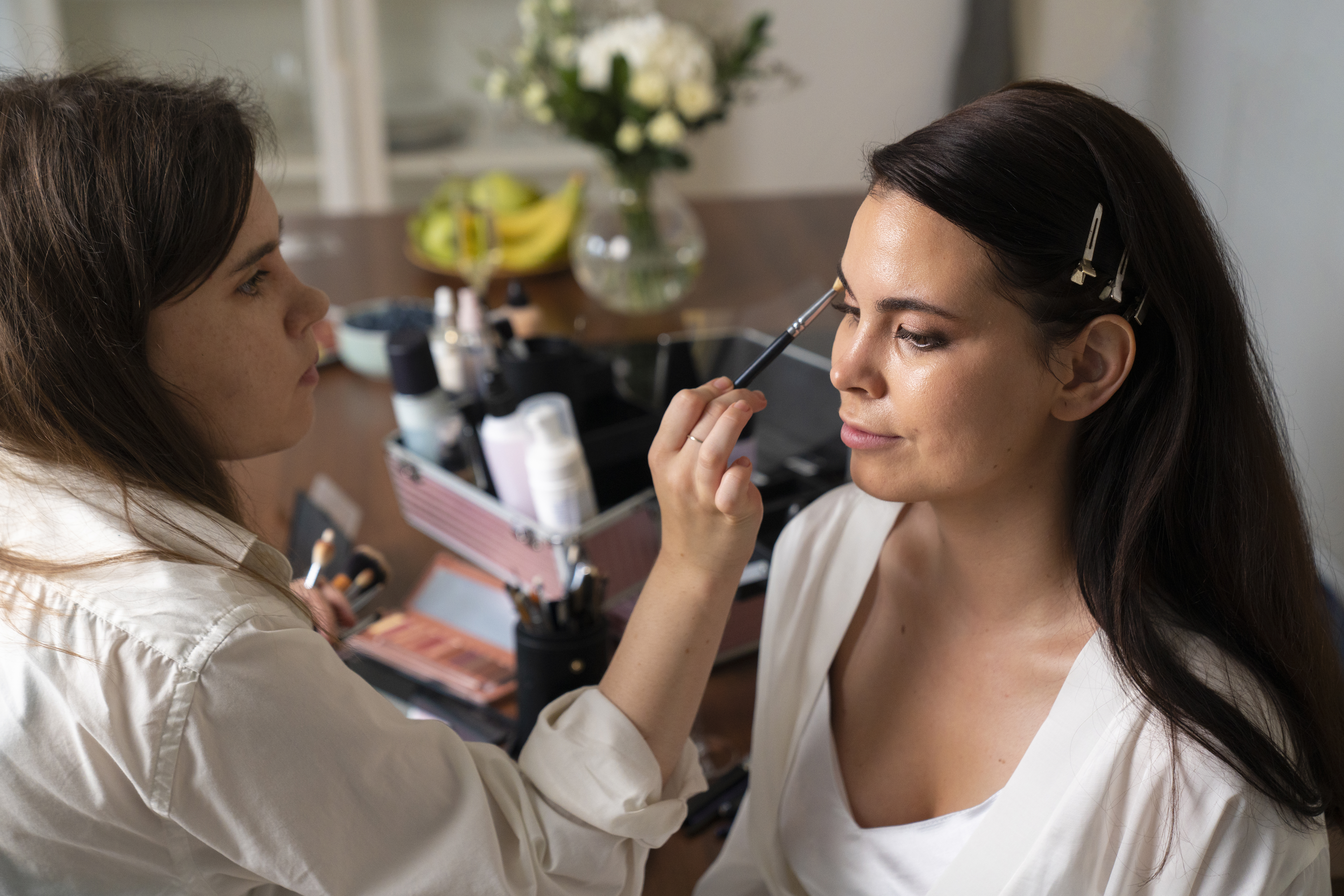 How far in advance eyebrow threading before event: bride getting ready with professional beauty prep