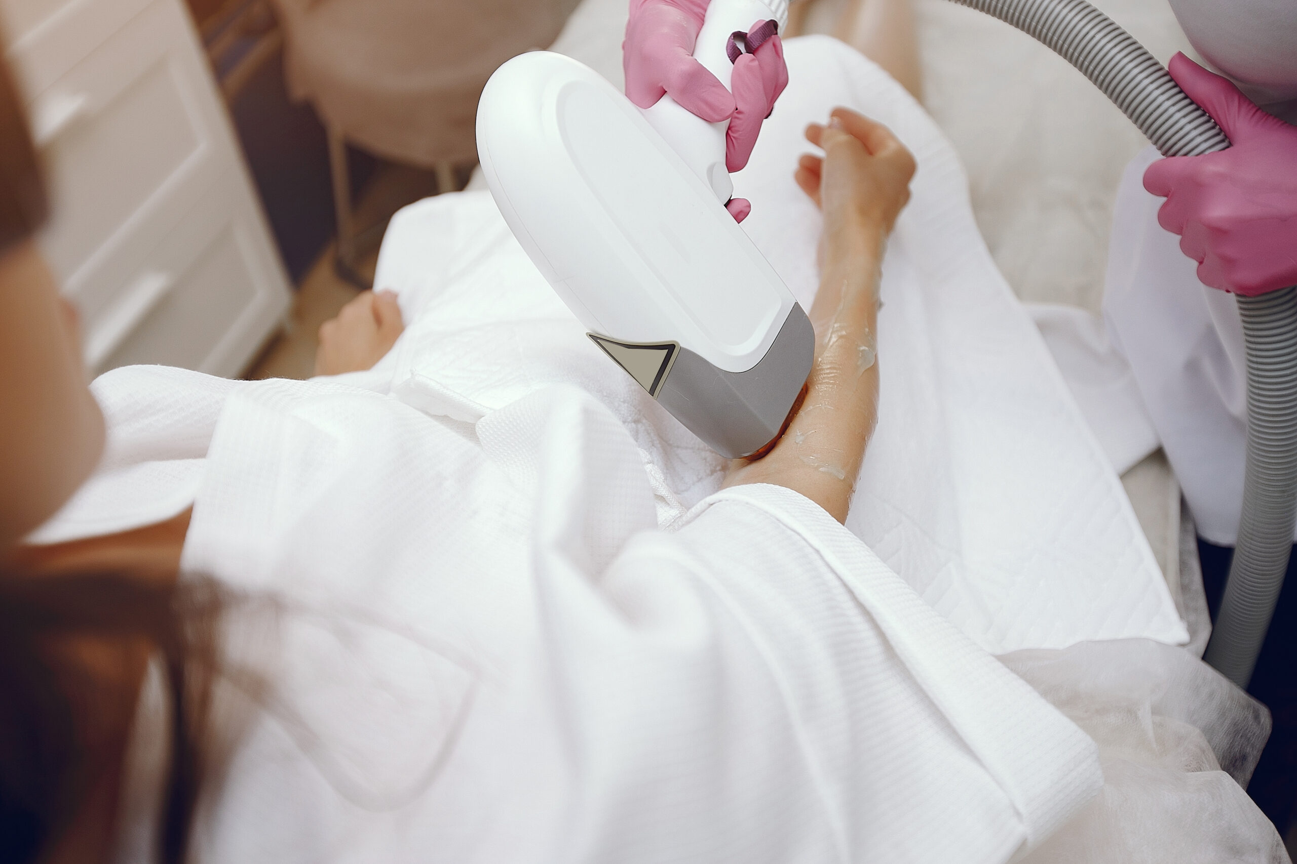 Technician performing laser hair removal on a client's arm near Park Slope Brooklyn