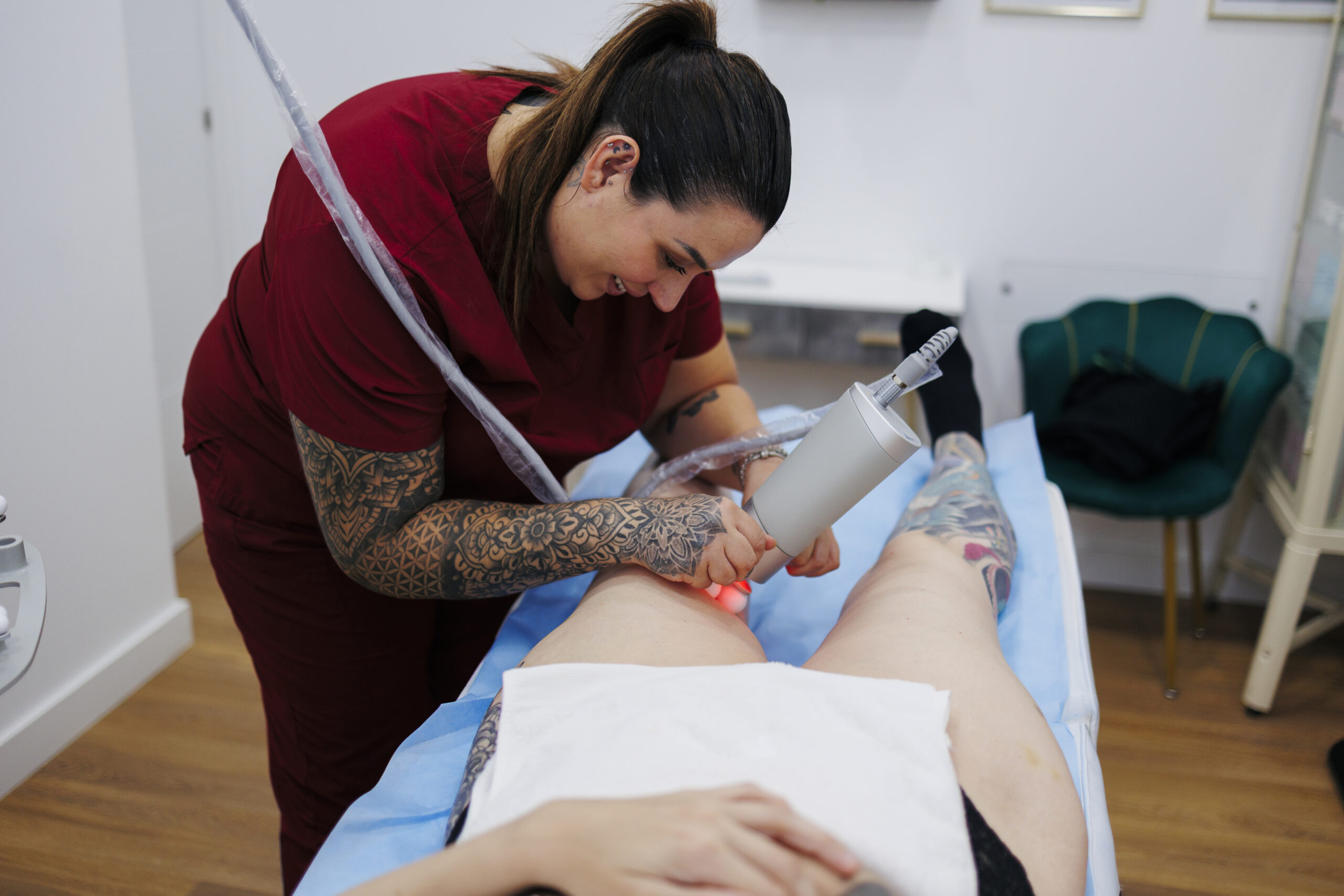 Technician performing an active laser hair removal treatment on a client in a Brooklyn clinic