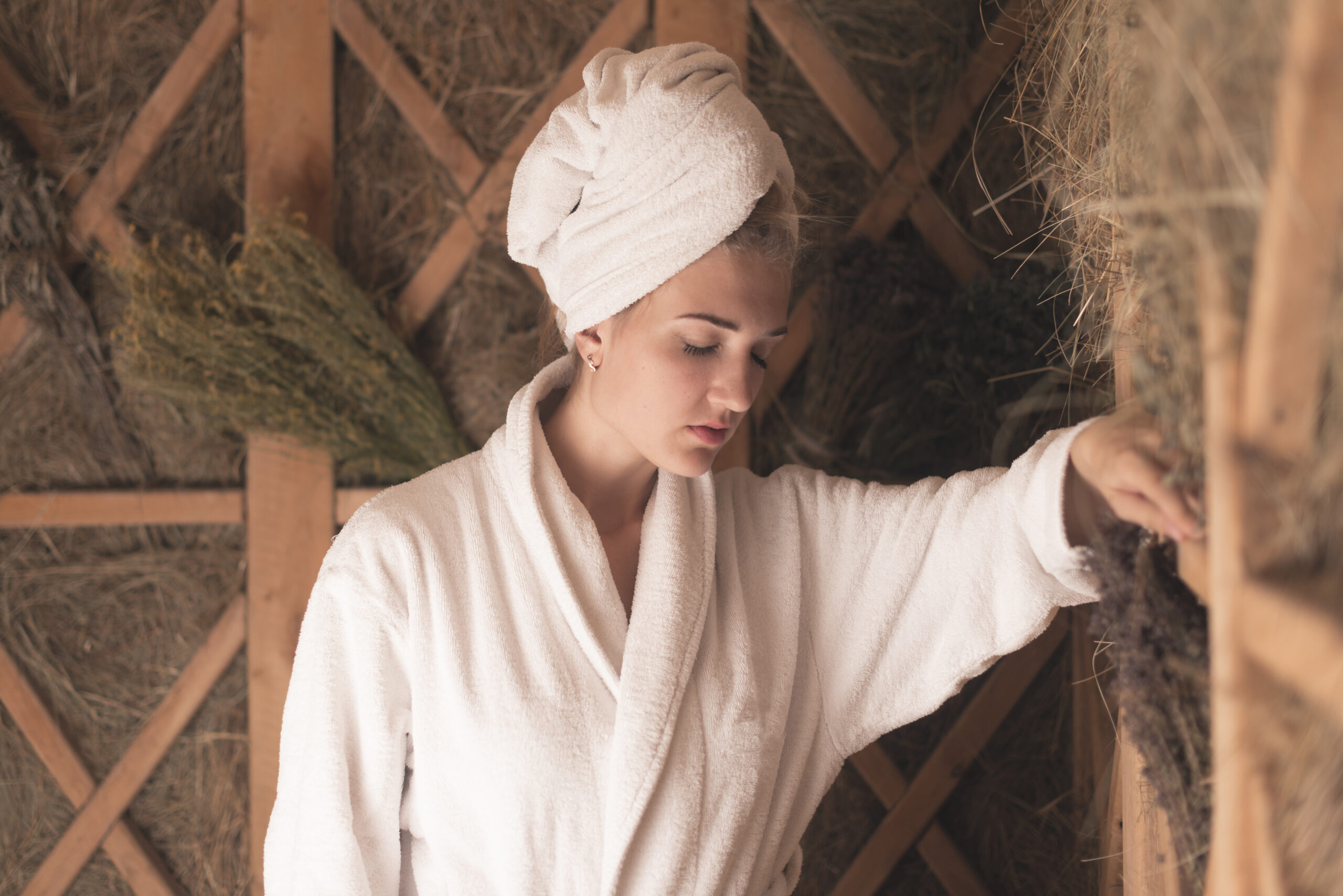 Lash extensions and swimming, sweating, sauna use: woman relaxing in a spa sauna