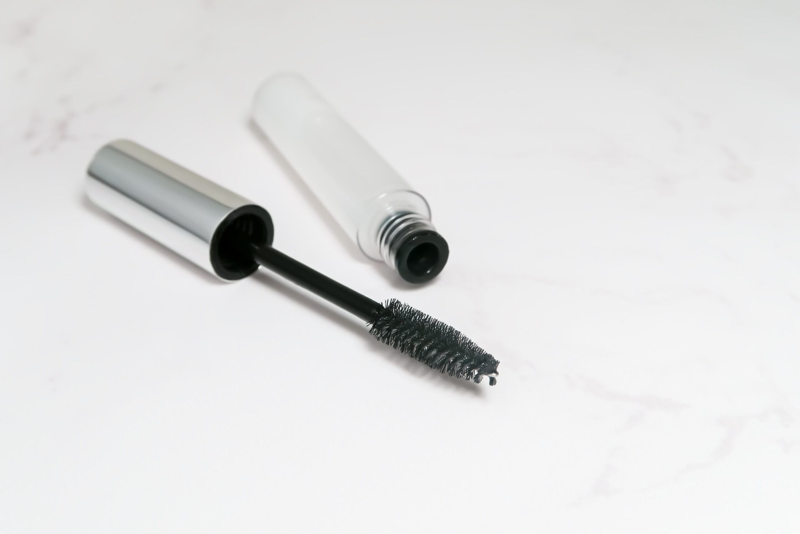 Lash serum bottle and wand, product used alongside lash extensions care routine